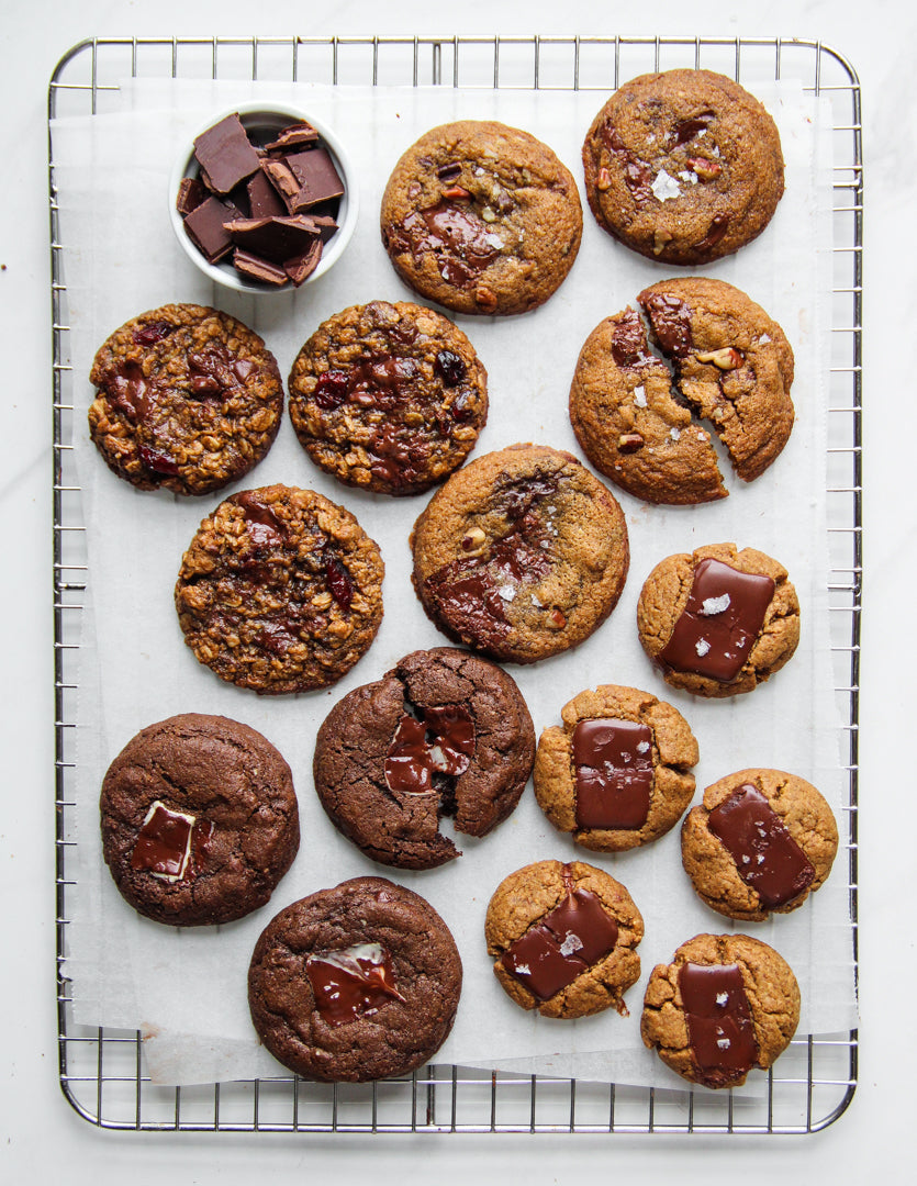 Various Truffle Thins Stuffed Cookies on a cookie sheet cooling.