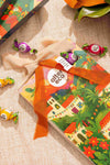 Colorful gift box with 'Alter Eco' label on a textured surface with candy accents.