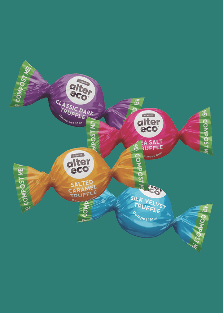 Assorted alter eco truffles in colorful packaging on a green background